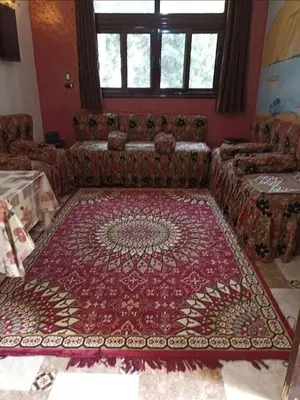 a living room with a couch and a rug at شقق للإيجار بأسوان in Aswan