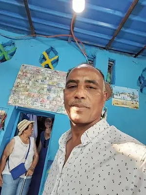 a man posing for a picture in a blue room at Relaxing Felucca Trips in Aswan