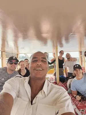 a man sitting in front of a group of people at Relaxing Felucca Trips in Aswan