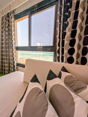 a bedroom with a bed and a window at Das Nistkästchen in Hurghada in Hurghada