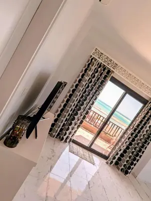 a room with a large window and a piano at Das Nistkästchen in Hurghada in Hurghada