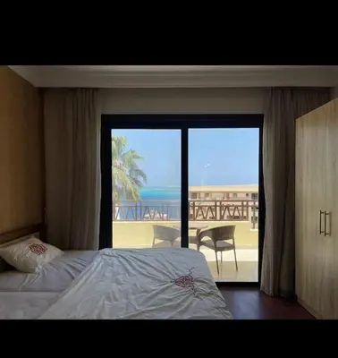 a bedroom with a bed and a view of the beach at The view hurghada in Hurghada