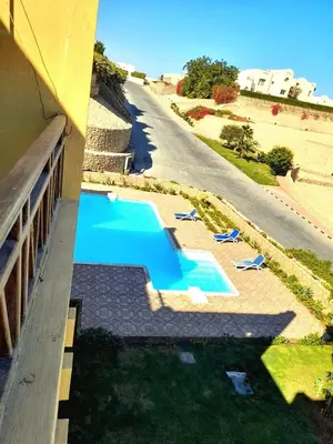 an overhead view of a swimming pool next to a building at The view hurghada in Hurghada