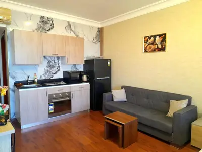 a living room with a couch and a kitchen at The view hurghada in Hurghada