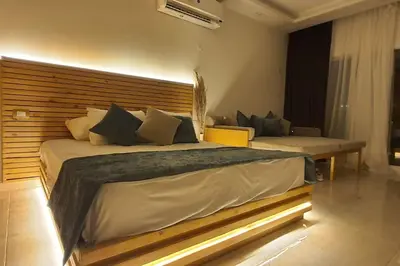 a bedroom with a large bed with a wooden headboard at Studio in Selena Bay Hurghada in Hurghada