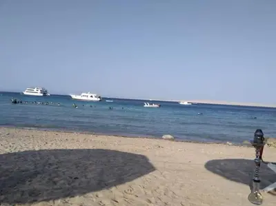 a parking meter on the beach with people in the water at Sheraton Plaza house near the beaches and near New Marina studio 428 in Hurghada