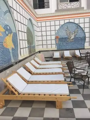 a row of chairs and tables in a room with tiles at Sheraton Plaza house near the beaches and near New Marina studio 428 in Hurghada