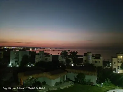 a view of a city at night with the ocean at Fanadir sea view Appartment in Hurghada
