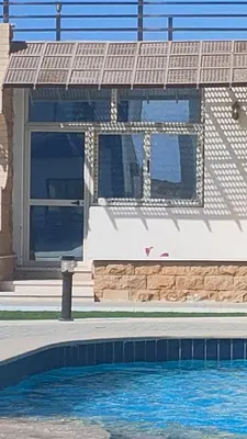a house with a swimming pool in front of it at Studio FOR RENT IN ELWAZRA EREA BEFOR EL GOUNA 5 MINUTES ONE BEDROOM in Hurghada