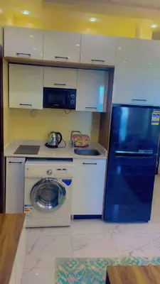 a kitchen with a washing machine and a refrigerator at جوليانا بتش in Hurghada