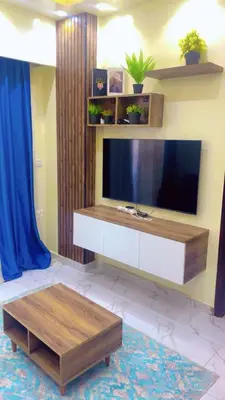a living room with a flat screen tv and a coffee table at جوليانا بتش in Hurghada