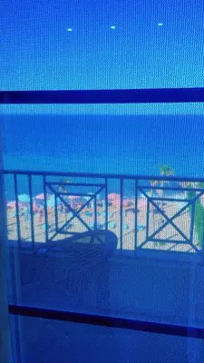 a view through a fence of a table on a balcony at جوليانا بتش in Hurghada