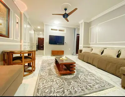 a living room with a couch and a table at Luxor family apartment in Luxor