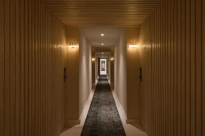 a hallway with a long corridor with doors and a carpet at Soleil Nile Cruise - Every Monday from Luxor for 4 & 7 Nights, and every Friday from Aswan for 3 & 7 Nights in Luxor
