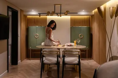 a woman standing in a kitchen with a table at Soleil Nile Cruise - Every Monday from Luxor for 4 & 7 Nights, and every Friday from Aswan for 3 & 7 Nights in Luxor