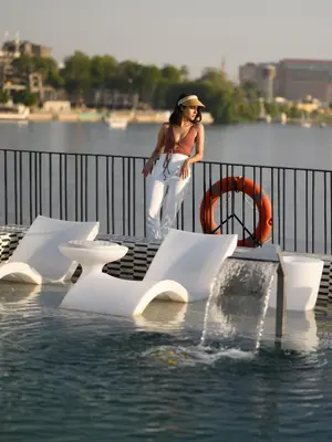 a woman standing next to a pool of water at Soleil Nile Cruise - Every Monday from Luxor for 4 & 7 Nights, and every Friday from Aswan for 3 & 7 Nights in Luxor