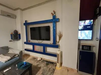 a living room with a tv on the wall at Apartment Duplex Flat - Private Garden - 2 Floors in Hurghada