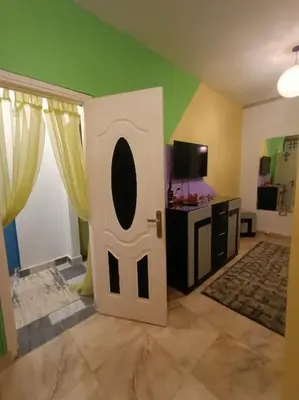 a room with a white door in a room with a tv at Apartment Duplex Flat - Private Garden - 2 Floors in Hurghada