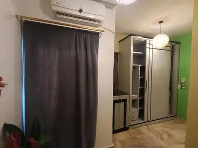 a room with a black curtain and a closet at Apartment Duplex Flat - Private Garden - 2 Floors in Hurghada