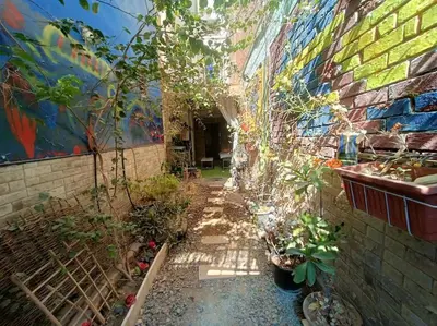 an alley with plants and a wall with a mural at Apartment Duplex Flat - Private Garden - 2 Floors in Hurghada