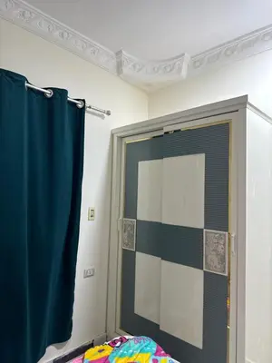 a bathroom with a shower with a blue shower curtain at Apartment all yours in Hurghada