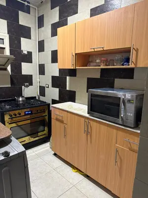 a kitchen with a microwave and a stove at Apartment all yours in Hurghada