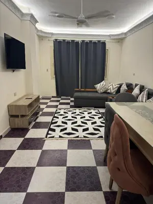 a living room with a couch and a table at Apartment all yours in Hurghada