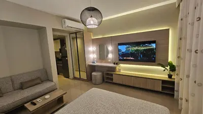 a living room with a couch and a tv in a bathroom at G Cribs Stylish Studio in Hurghada