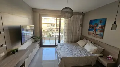 a bedroom with a bed and a large window at G Cribs Stylish Studio in Hurghada