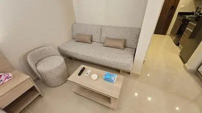a living room with a couch and a table at G Cribs Stylish Studio in Hurghada