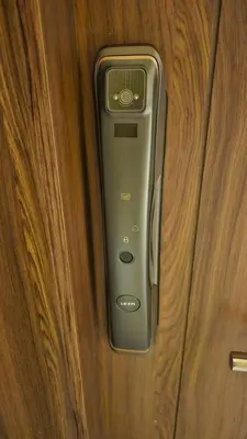 a cell phone is on a wooden door at G Cribs Stylish Studio in Hurghada