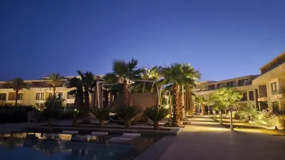 a resort courtyard with palm trees and a swimming pool at G Cribs Stylish Studio in Hurghada