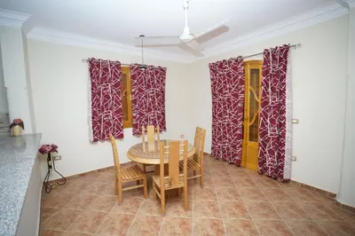 a dining room with a table and chairs at Morning Star Apartment in Luxor