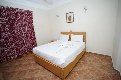a bedroom with a bed with white sheets at Morning Star Apartment in Luxor