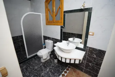 a bathroom with a toilet and a sink at Morning Star Apartment in Luxor