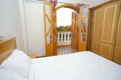 a bedroom with a bed and an open door at Morning Star Apartment in Luxor