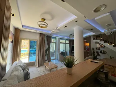 a living room with a couch and a table at Luxury Smart Home- Villa Duplex in Hurghada