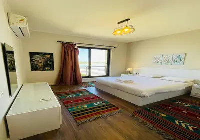 a bedroom with a bed and a large window at Cozy 3 Bedrooms Apartment at Cyan El-Gouna in Hurghada