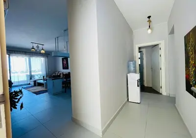 a kitchen with a white wall and a white refrigerator at Cozy 3 Bedrooms Apartment at Cyan El-Gouna in Hurghada