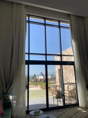 a large window with a view of a patio at Cozy 2BR Seaview loft in Mesca Somabay in Hurghada