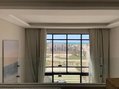 a room with a large window with a view at Cozy 2BR Seaview loft in Mesca Somabay in Hurghada