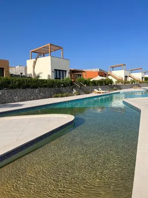 a pool of water with a building in the background at Cozy 2BR Seaview loft in Mesca Somabay in Hurghada