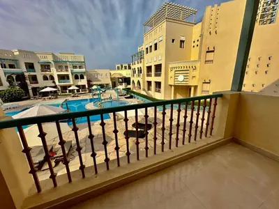 a balcony with a view of a pool and buildings at Gouna Luxuy Condo Hotel in El Gouna