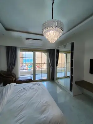 a bedroom with a bed and a chandelier at جوليانا سما جروب in Hurghada