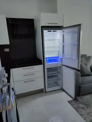 an empty refrigerator with its door open in a kitchen at جوليانا سما جروب in Hurghada