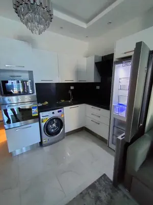 a kitchen with a refrigerator and a washing machine at جوليانا سما جروب in Hurghada