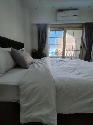 a large white bed with a view of the ocean at جوليانا سما جروب in Hurghada