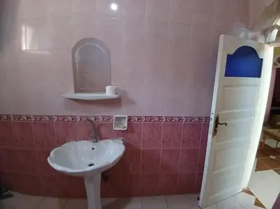 a bathroom with a sink and a mirror at Sobhy Kana House in Aswan