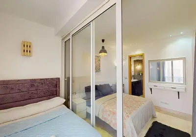a bedroom with two beds and a glass wall at Cozy 2 Bedroom-WS3 at SCARAB Elgouna in Hurghada
