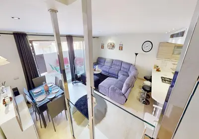 a living room with a purple couch and a table at Cozy 2 Bedroom-WS3 at SCARAB Elgouna in Hurghada